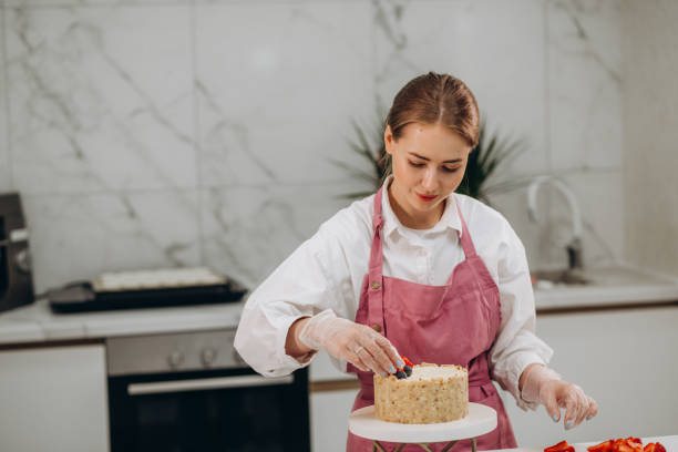 istock Female chef decorate cheesecake before serving for breakfast in restaurant kitchen 1535916489