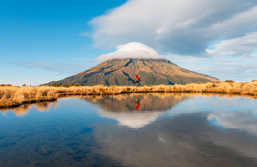 Reflection of Mt Taranaki Egmont in lake water on a nice day.