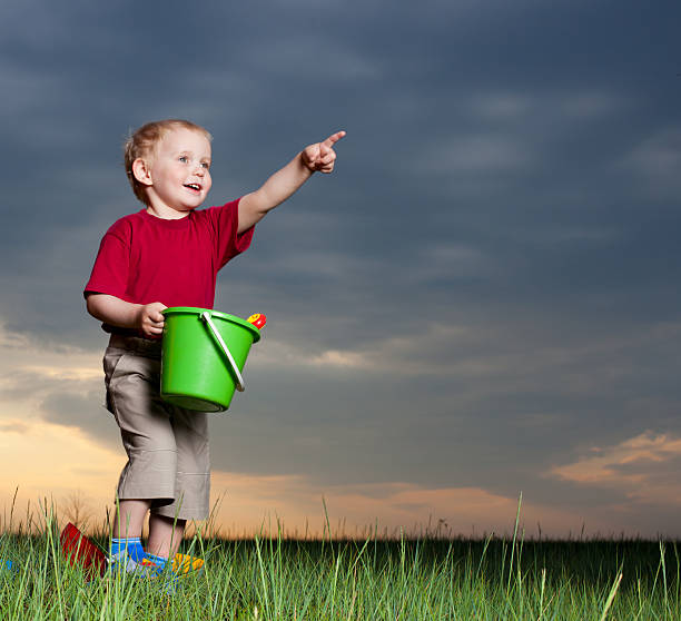 istock Cheerful boy with toys on nature 153592513