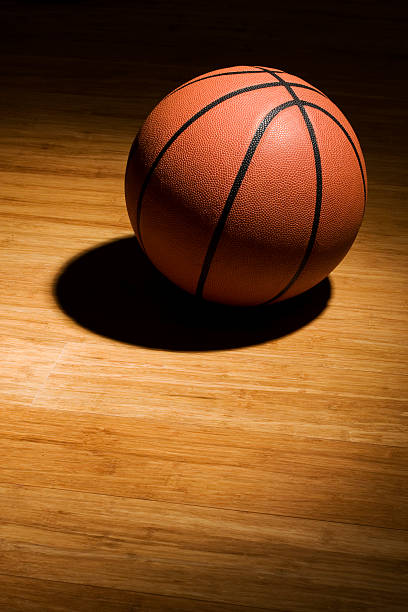 istock Basketball sitting on wood floor 153593167