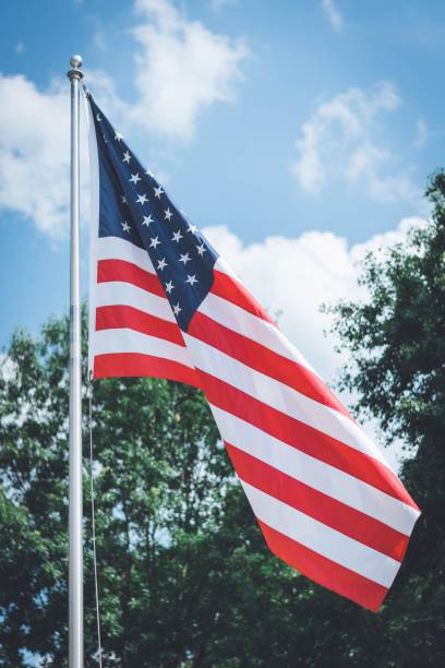 istock USA flag billowing in the wind on a sunny day. 1535946138