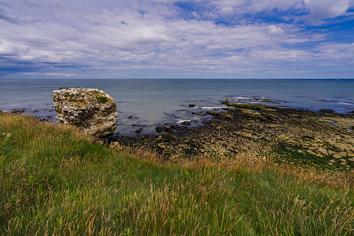 Jack Rock near the Souther Lighthouse in Sunderland viewed from the nearby clifftop. Jack Rock is a sea stack off the coast of North East England