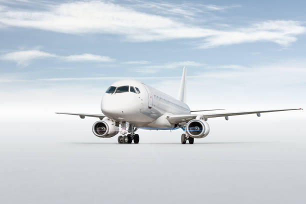 istock White passenger aircraft isolated on bright background with sky 1535970714