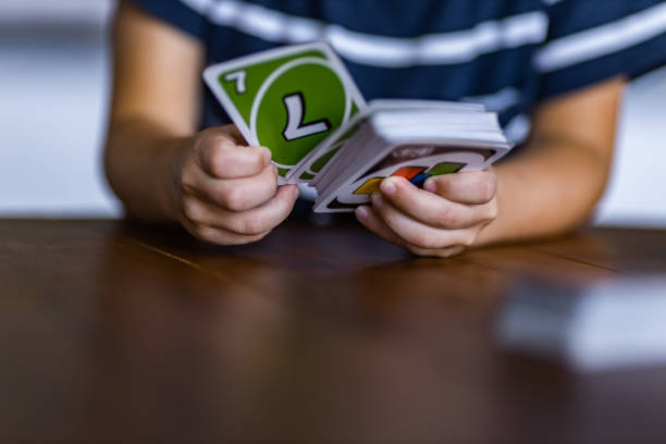 Close up of unrecognizable child dealing cards. Copy space.