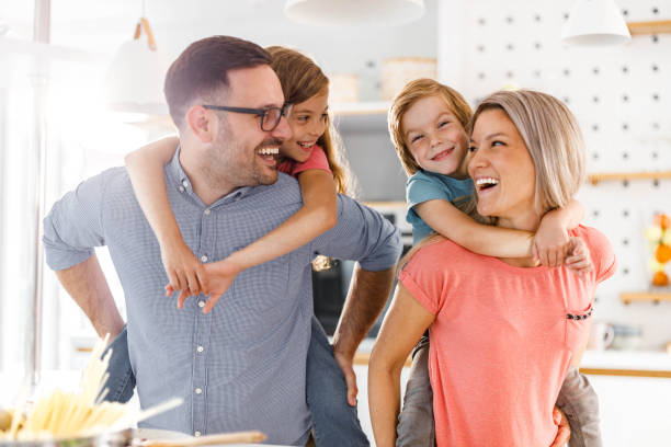 istock Young happy family having fun while piggybacking in the kitchen. 1536027471