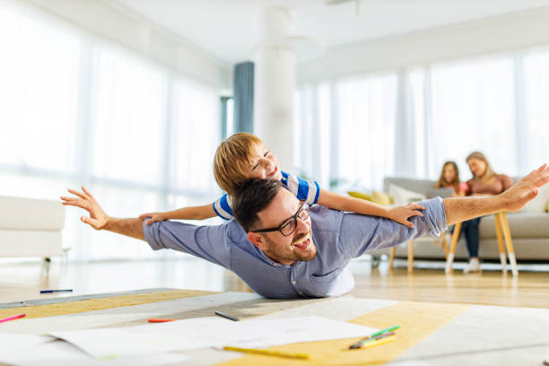 istock Playful father and son having fun on floor at home. 1536029011