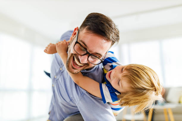 istock Playful father and son having fun while piggybacking at home. 1536030555