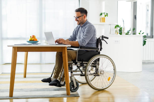 istock Disabled businessman working on laptop at home. 1536038772