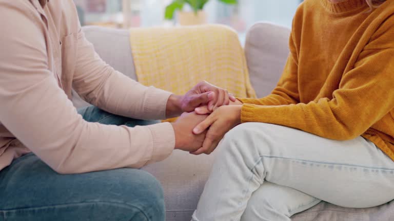 Closeup, couple and people holding hands for love, care and gratitude at home. Life partner, helping hand and loyalty of kindness, commitment and support of trust, hope or respect of empathy together