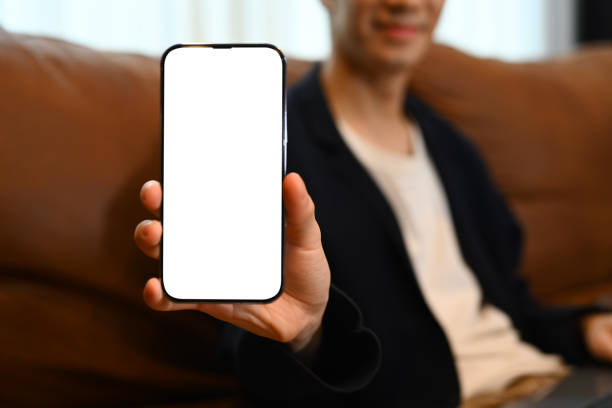 istock Man showing smartphone with white screen at camera, recommending mobile app, for advertise or text message. 1536087823