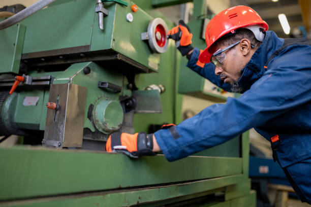 istock A dark-skinned industrial worker prepares a metalworking machine for work 1536109020
