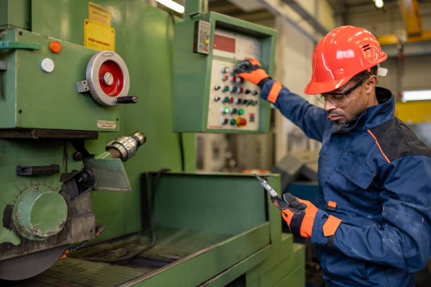 istock Industrial worker prepares a metalworking machine for work 1536109025