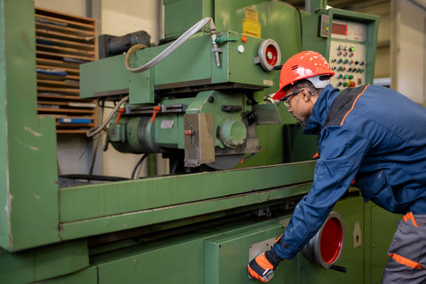 istock A dark-skinned industrial worker prepares a metalworking machine for work 1536109026