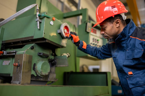istock A dark-skinned industrial worker prepares a metalworking machine for work 1536109030