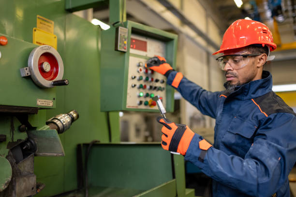 istock A dark-skinned industrial worker prepares a metalworking machine for work 1536109031