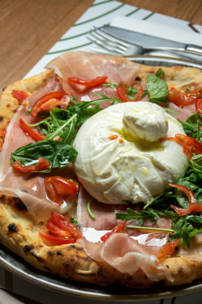 istock Neapolitan pizza with burrata mozzarella and cherry tomatoes 1536164736