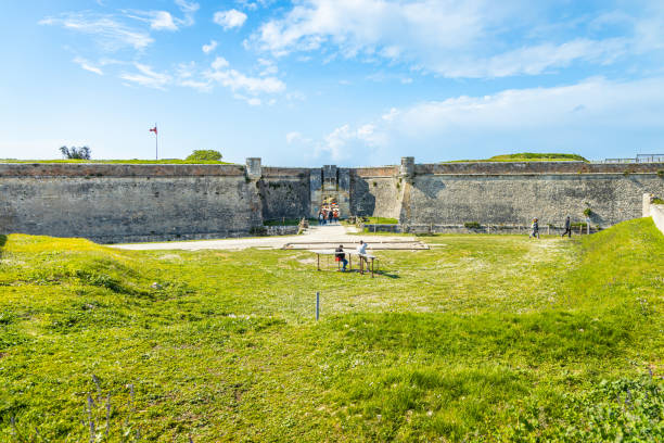 Main entrance of the stronghold of Fort la Prée in La Flotte Main entrance of the stronghold of Fort la Prée in La Flotte, France with tourists visiting flotte stock pictures, royalty-free photos & images