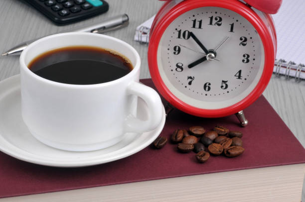 Coffee break Cup of coffee with coffee beans and an alarm clock tasse café stock pictures, royalty-free photos & images