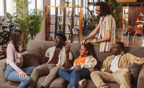 istock multiracial friends having fun and laughing, diverse people talking sitting together in a sofa 1536182802