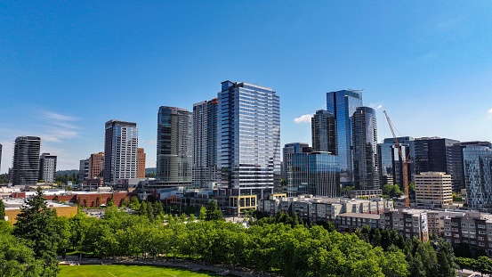 Bellevue, United States – June 24, 2023: A bustling cityscape featuring the tall buildings of the downtown area of Bellevue, Washington.