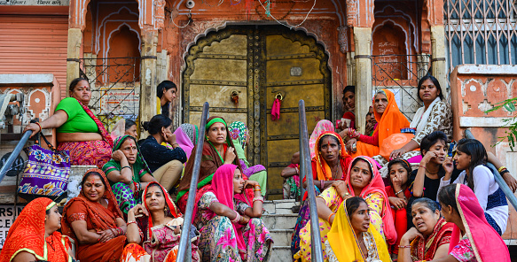 Jaipur, India - Nov 1, 2017. Indian people in colorful traditional dress sitting on street at Pink City in Jaipur, India.
