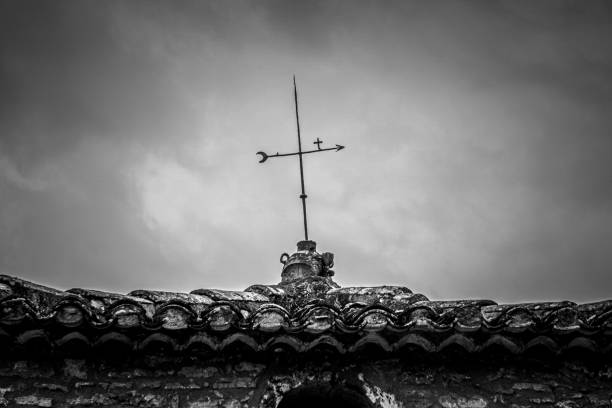 silhouette of a steeple with flying pigeon