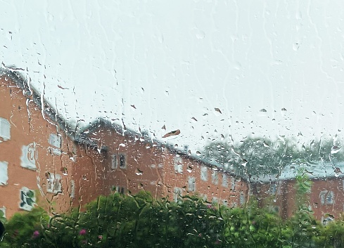 Raindrops on window against apartment building i Scandinavia