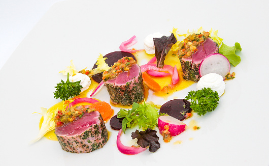 Raw and cooked tuna dish with vegetables