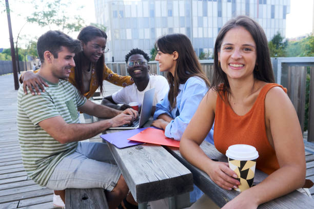istock Multiethnic friends sitting outdoors doing homework together at school campus. 1536246254