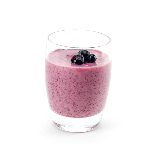 Superfruit Smoothie Blueberry and pomegranate smoothie. Isolated on white. Garnished with blueberries. fruit garnish stock pictures, royalty-free photos & images
