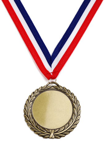 Gold medal isolated on white with blank face for text, concept for winning or success