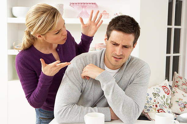 Young couple arguing in their home Young Couple Having Argument In Kitchen At Home bossy stock pictures, royalty-free photos & images