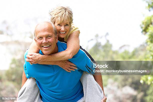 Senior Couple Exercising In Park Stock Photo - Download Image Now - Senior Adult, Active Seniors, Couple - Relationship
