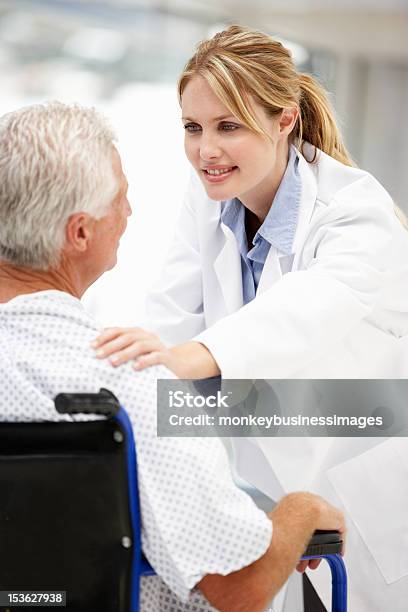 Senior Patient With Young Doctor Stock Photo - Download Image Now - 20-29 Years, 60-69 Years, Adult