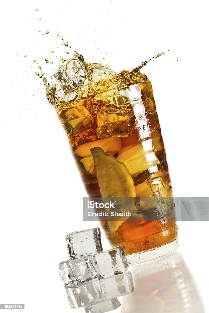 Ice splash in a glass with lemon tea Ice splash in a glass with lemon tea. Ice Tea Stock Photo