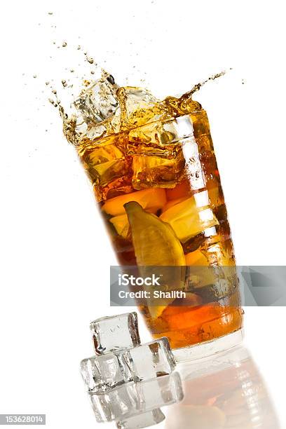 Ice Splash In A Glass With Lemon Tea Stock Photo - Download Image Now - Ice Tea, Spilling, Drinking Glass