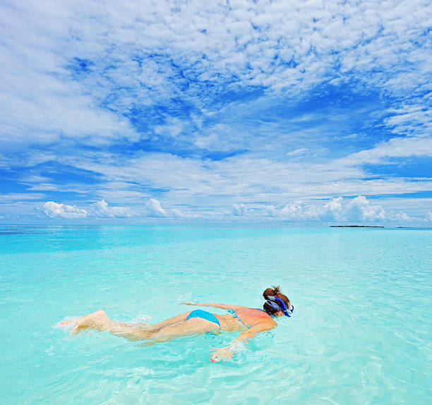 istock Woman with snorkeling mask diving 153629140