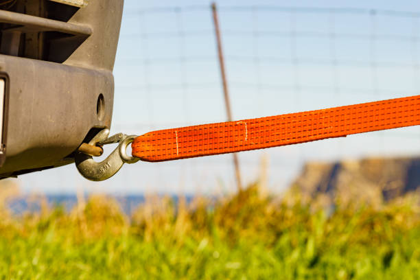 Woman assembling towing line to a broken car
