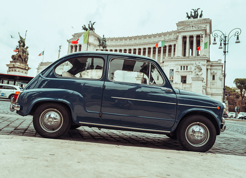 Rome, Italy, June 4, 2023: Vintage car parade on June 4, 2023 in Roma, Italy. Old vintage cars are parked in front of Vittorio Emanuele Monument, participating to a parade