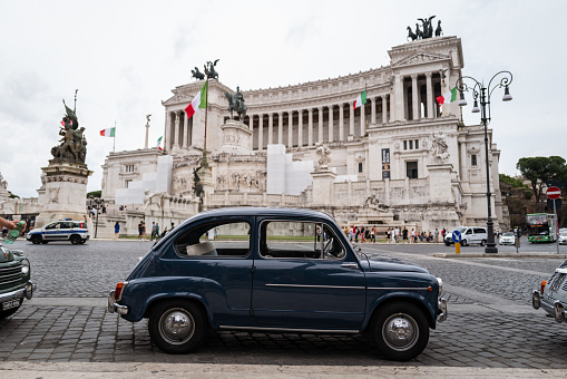 Rome, Italy, June 4, 2023: Vintage car parade on June 4, 2023 in Roma, Italy. Old vintage cars are parked in front of Vittorio Emanuele Monument, participating to a parade