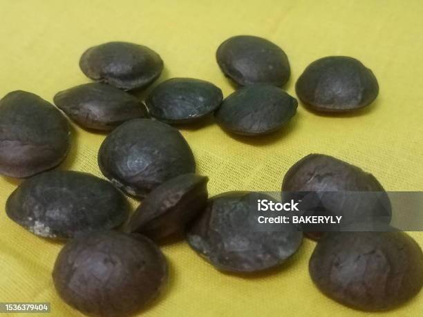 Plukenetia Volubilis Commonly Known As Sacha Inchi Sacha Peanut Mountain Peanut Inca Nut Or Incapeanut Seeds Closeup On Yellow Background Stock Photo - Download Image Now