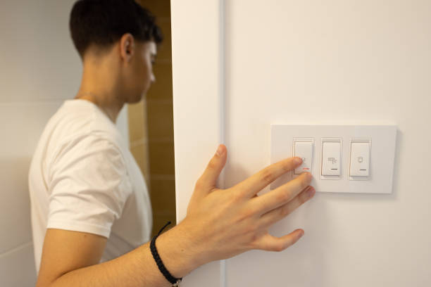 istock Unrecognizable teenage boy, turn on the light switch for the bathroom 1536398075