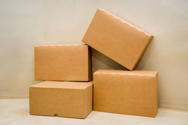 istock Pile of cardboard boxes arranged in a stack on a beige colored background 1536398595