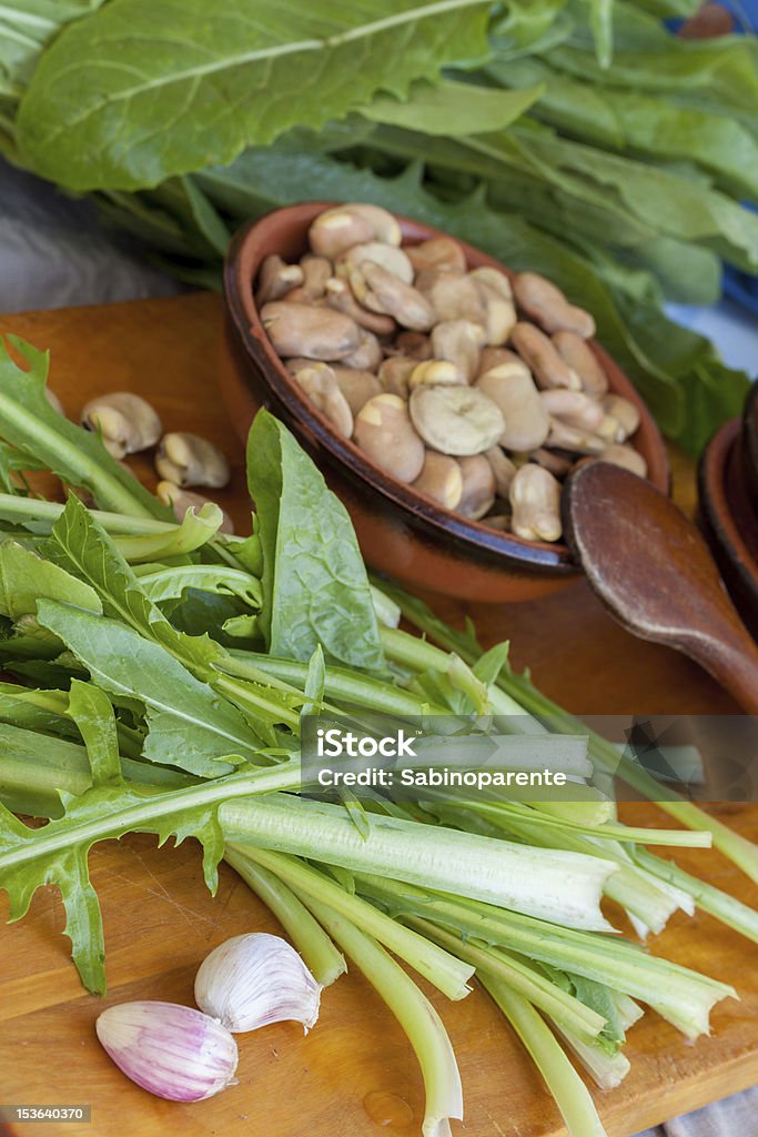Fava beans and chicory Fresh raw broad beans and wild green chicory. Agriculture Stock Photo