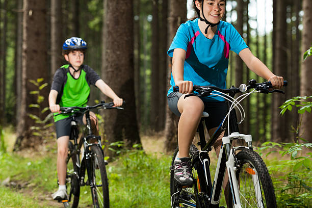 istock Girl and boy biking 153640489