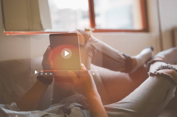 istock man using computer tablet apps, watching contents reading good news in social network, happy older female sitting on couch, holding electronic device, looking at screen 1536416474