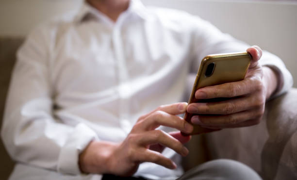 istock Happy relaxed businessman sitting on couch at home holding smartphone, using cell phone mobile apps, Social media influence concept 1536418594