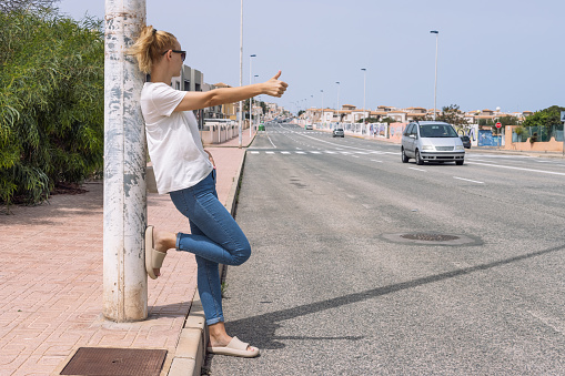 A young woman catches a car on the road close-up on her hand, automatic stop, automatic braking