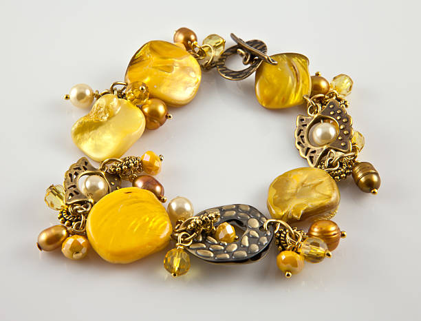 Yellow bracelet Yellow bracelet on silver background trishz stock pictures, royalty-free photos & images