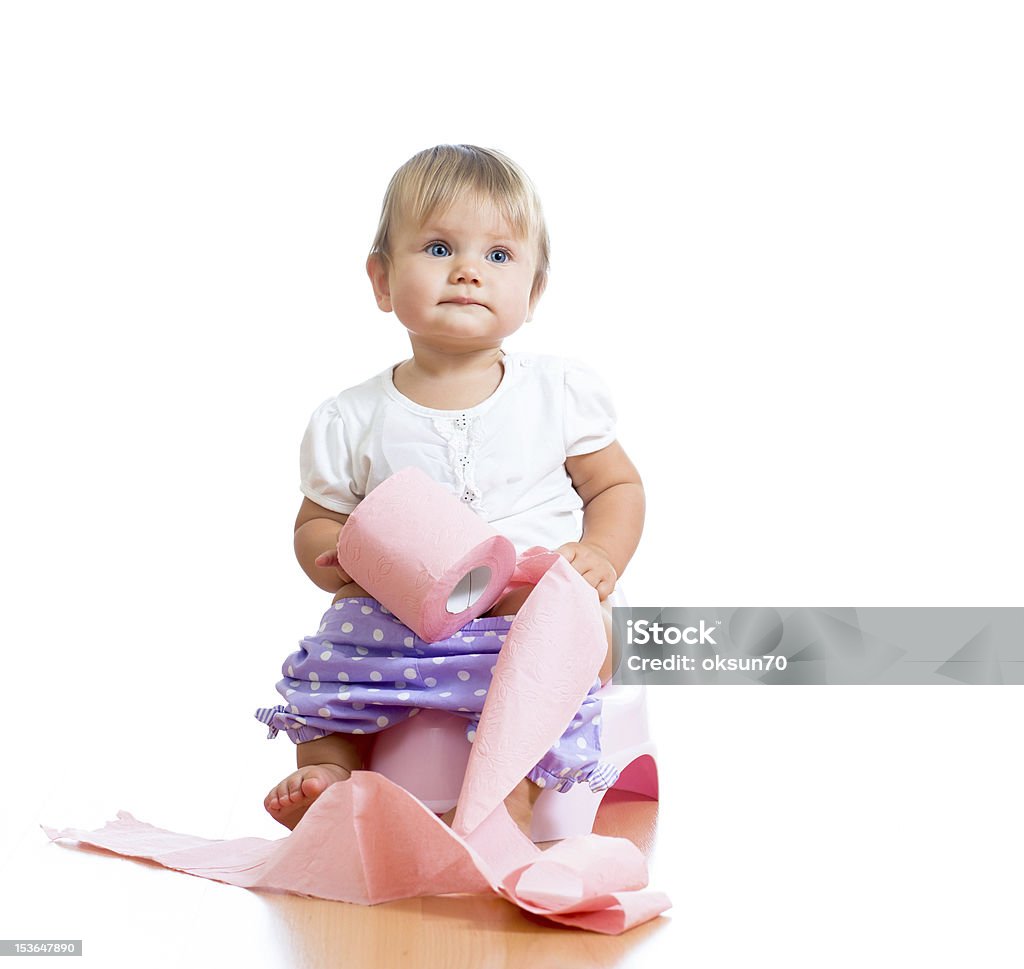 funny baby sitting on chamber pot with toilet paper roll Baby - Human Age Stock Photo